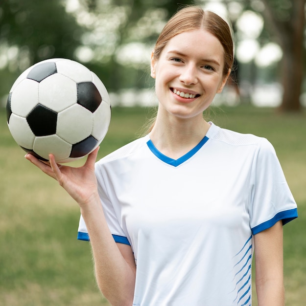 Free Photo happy woman holding ball outside