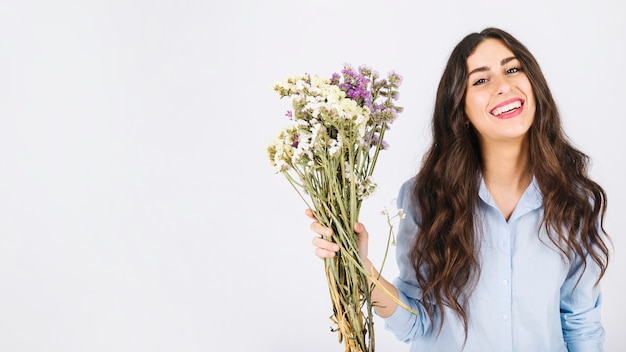 Happy woman holding bouquet of flowers