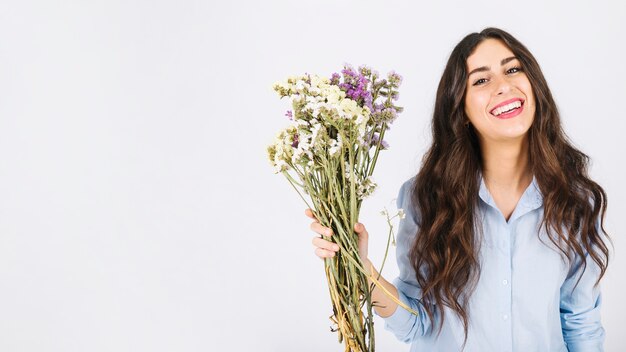 Happy woman holding bouquet of flowers