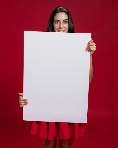 Happy woman holding an empty banner