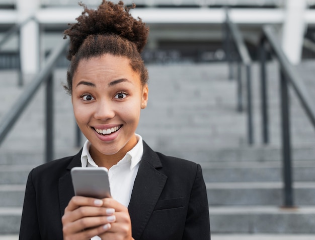 Happy woman holding phone