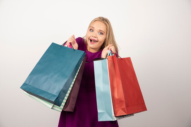 Happy woman holding shopping bags.