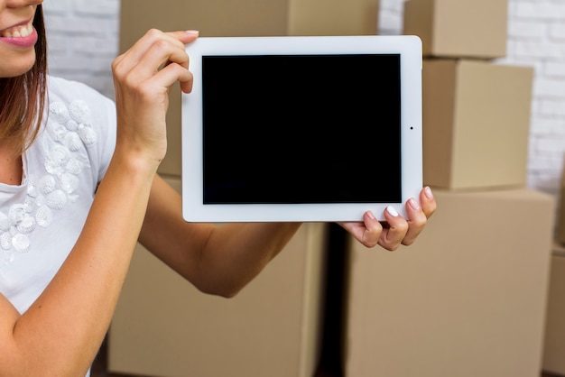 Happy woman holding a tablet mockup