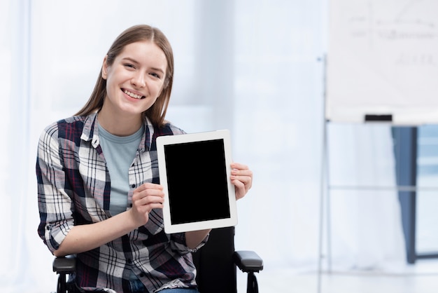 Happy woman holding tablet