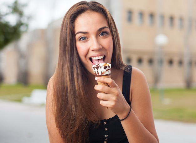 Free photo happy woman licking delicious ice cream.