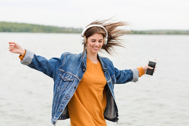 Free photo happy woman listening music in nature