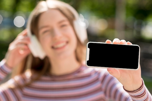 Free photo happy woman listening to music