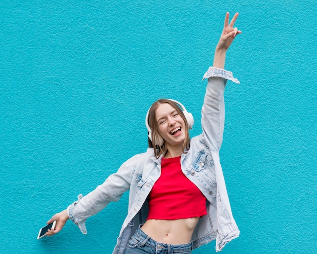 Free photo happy woman listening to music