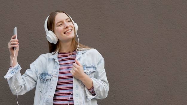 Free photo happy woman listening to music