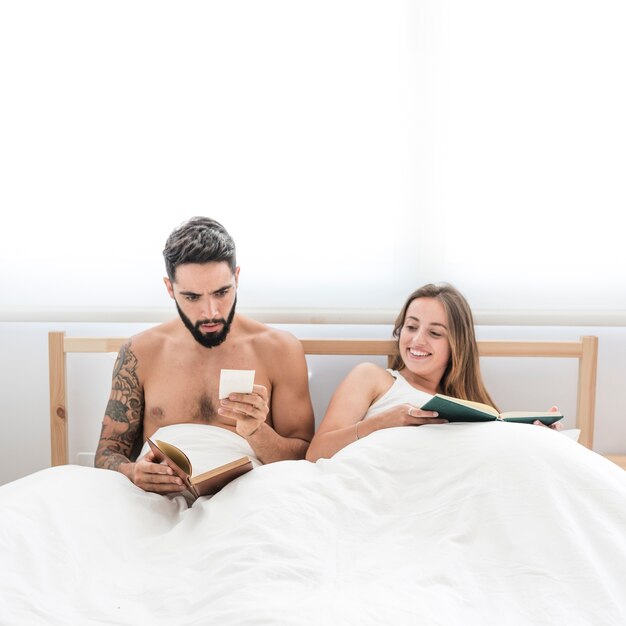 Happy woman looking at her husband reading note