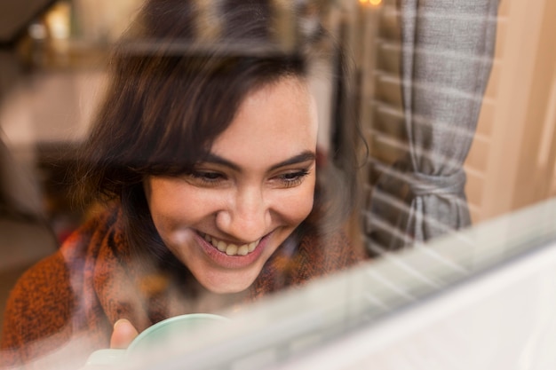 Happy woman looking on the window