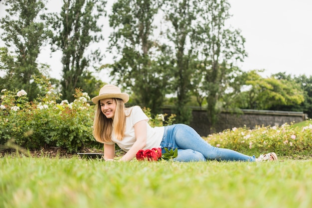 Happy woman lying on grass 