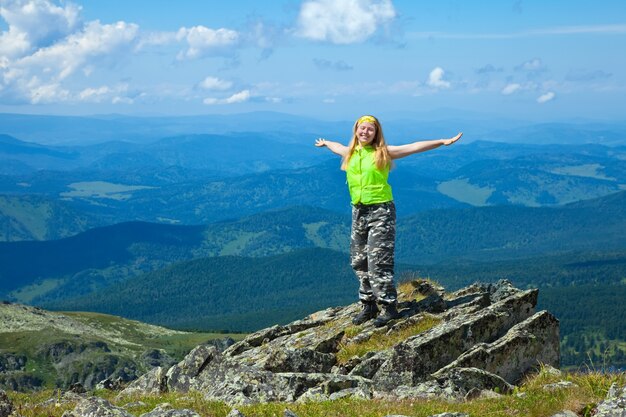 happy woman  at mountain peak