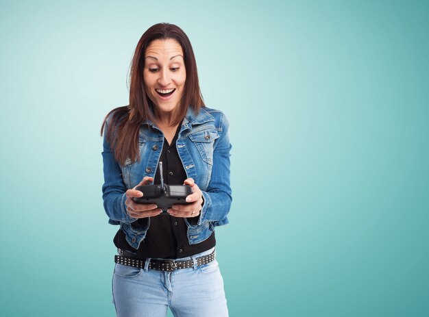 Happy woman playing with a radio control