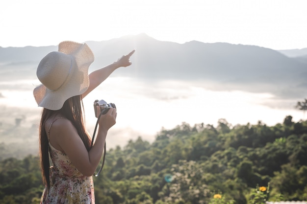 Happy woman pointing on the viewpoint