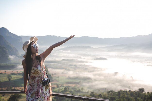 Happy woman pointing on the viewpoint