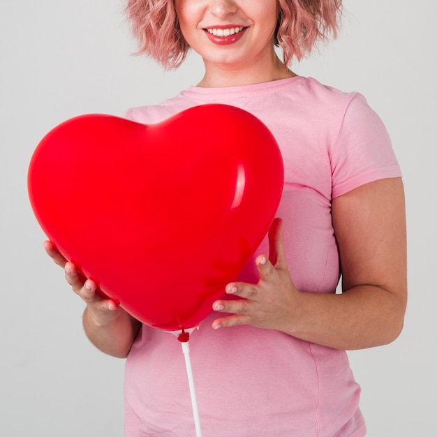 Happy woman posing with balloon