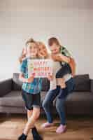 Free photo happy woman posing with her children for mother's day