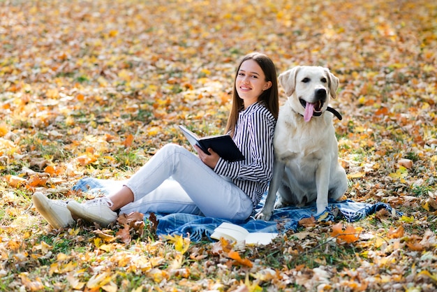 Happy woman posing with her labrador