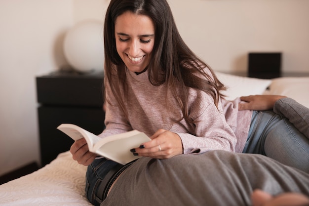 Happy woman reading book with spouse