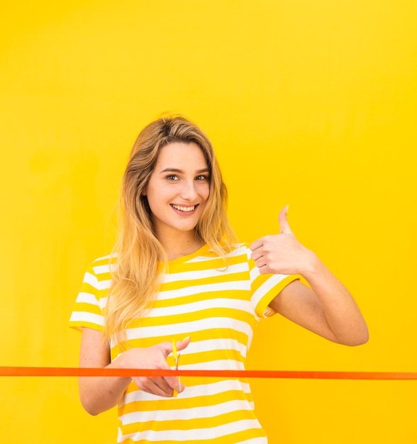 Free Photo happy woman ready to cut red ribbon