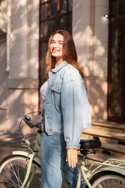 Happy woman riding her bike outside in the city