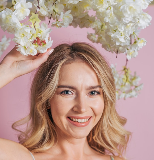 Free Photo happy woman's face holding bunch of white flowers