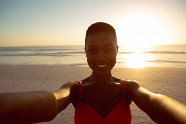 Happy woman standing on the beach