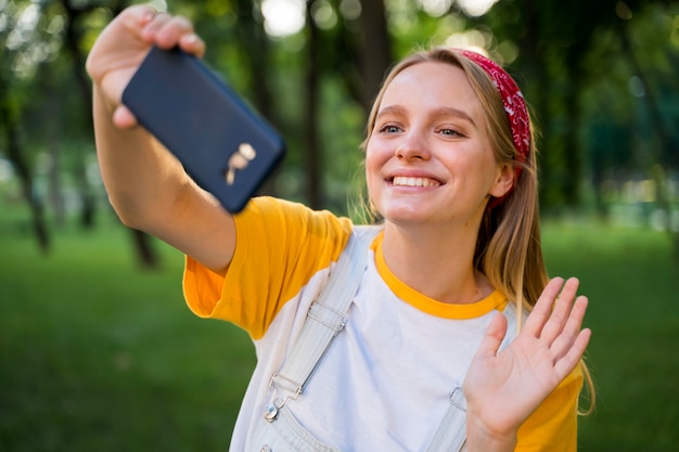 Free photo happy woman taking selfie outdoors