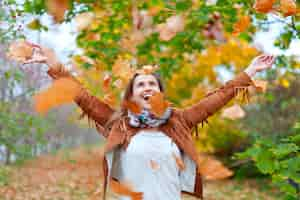 Free photo happy woman throws  leaves