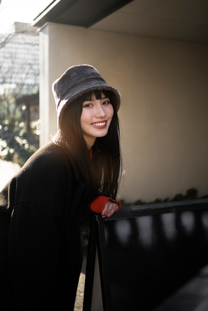 Happy woman wearing bucket hat medium shot