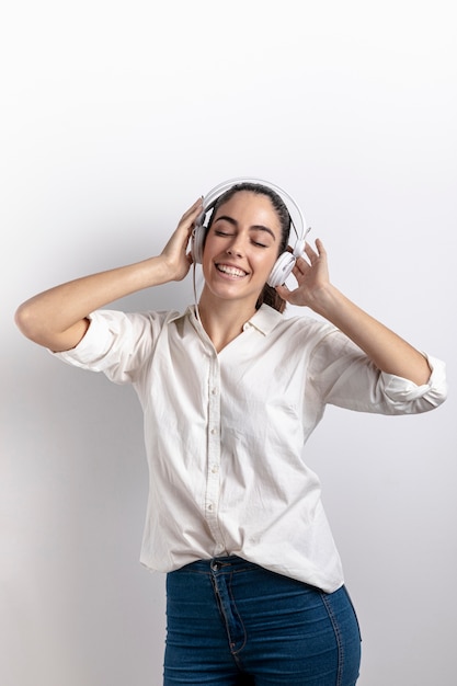 Happy woman wearing headphones with copy space