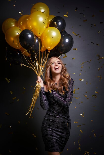 Happy woman with balloons celebrating her birthday