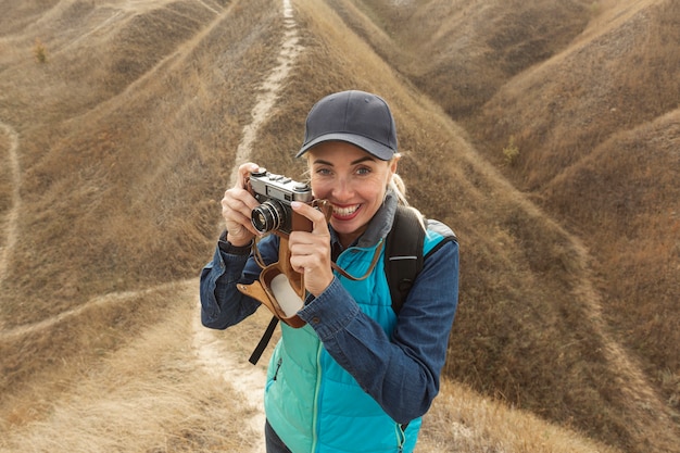 Free photo happy woman with camera outdoors