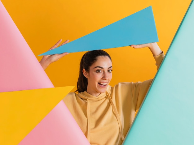 Free photo happy woman with geometric shapes