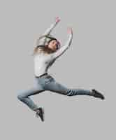 Free photo happy woman with headphones jumping in the air