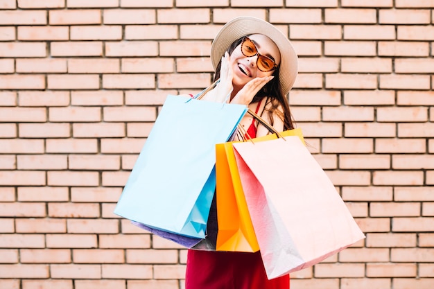 Free photo happy woman with paper bags