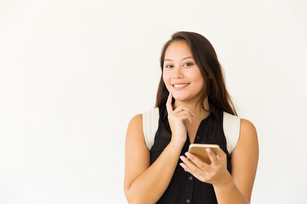 Happy woman with smartphone smiling 