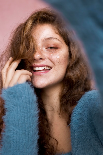 Happy woman with white flowers on her face