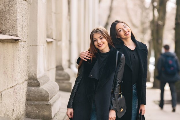 Happy women posing on the street