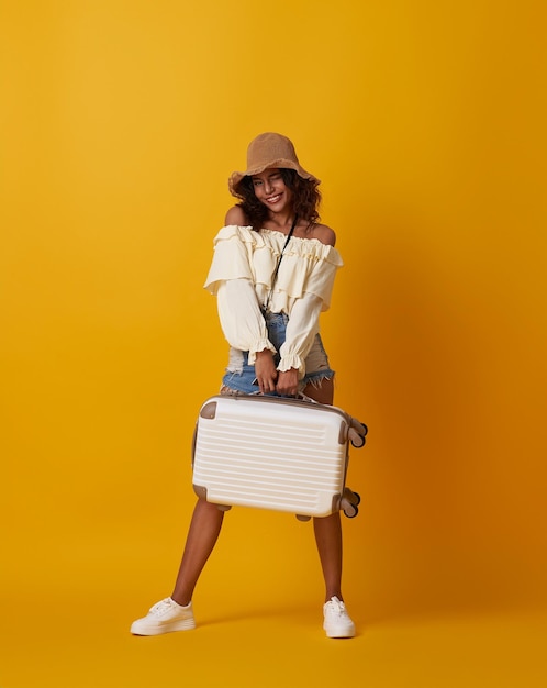 Free photo happy young african tourist woman holding baggage going to travel on holidays