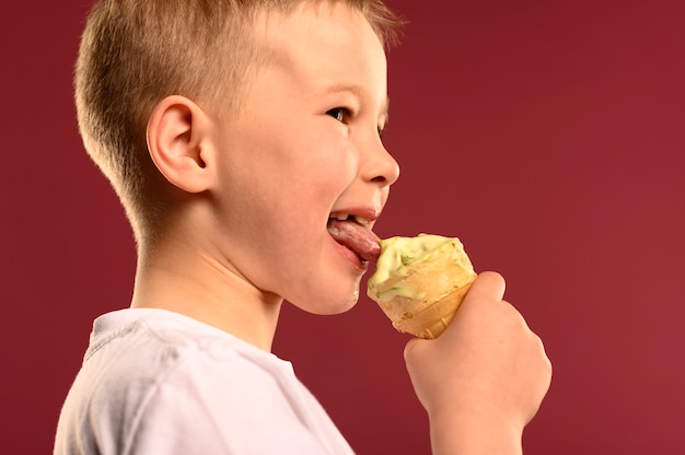 Free Photo happy young boy eating ice cream