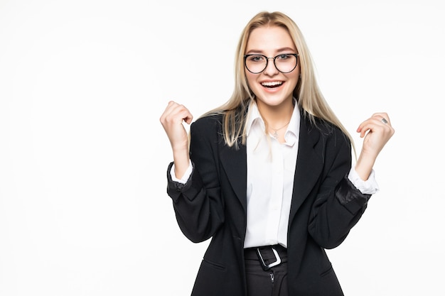 Free Photo happy young business woman doing winner gesture, keeping eyes closed posing isolated on grey wall