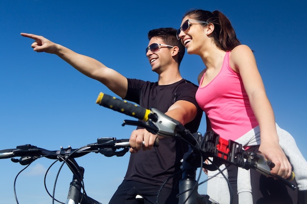 Happy young  couple on a bike ride in the countryside