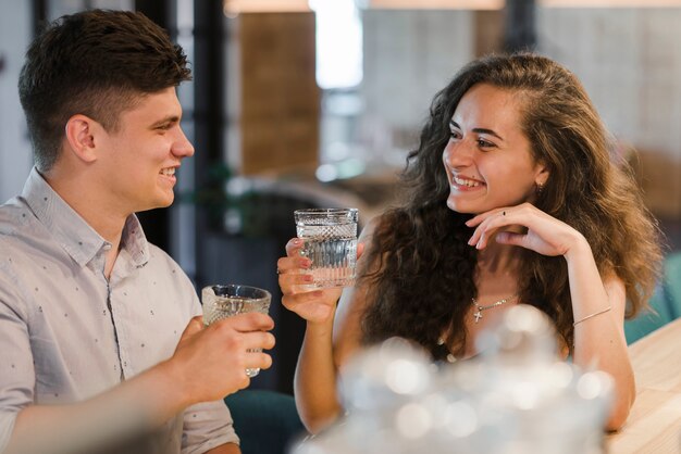 Happy young couple enjoying drinks