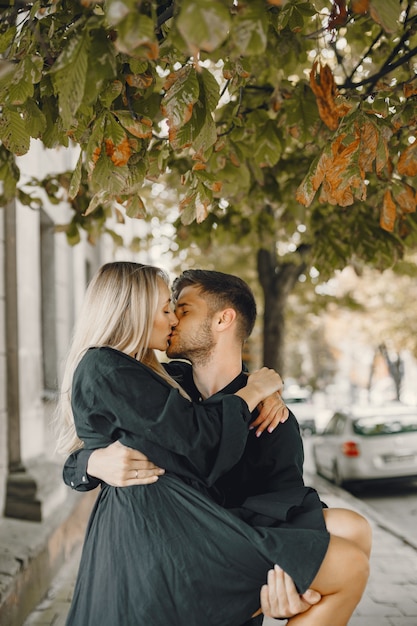 Happy young couple hugging and kissing outdoors