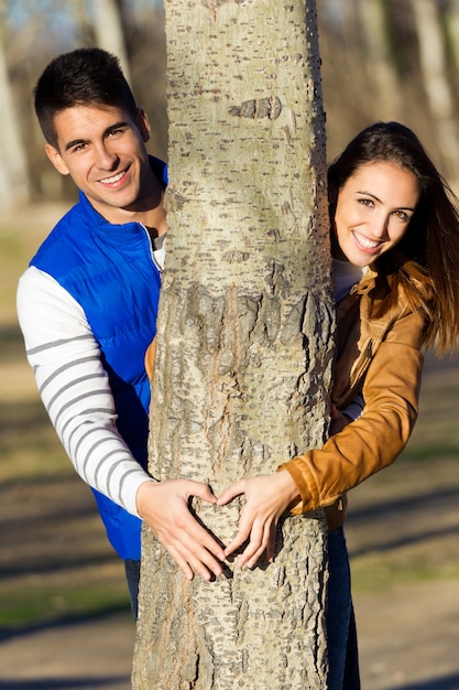 Free photo happy young couple  in love having fun at the park