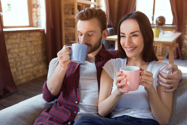 Happy young couple relax at modern home living room indoor Couple in love  Beginning of a Love Story