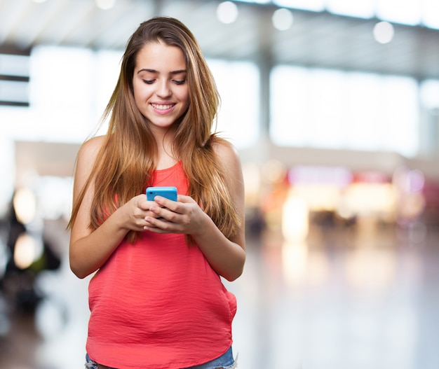 happy young cute woman typing a text on mobile on white