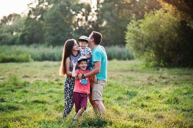 Happy young family mother father two children son on nature having fun